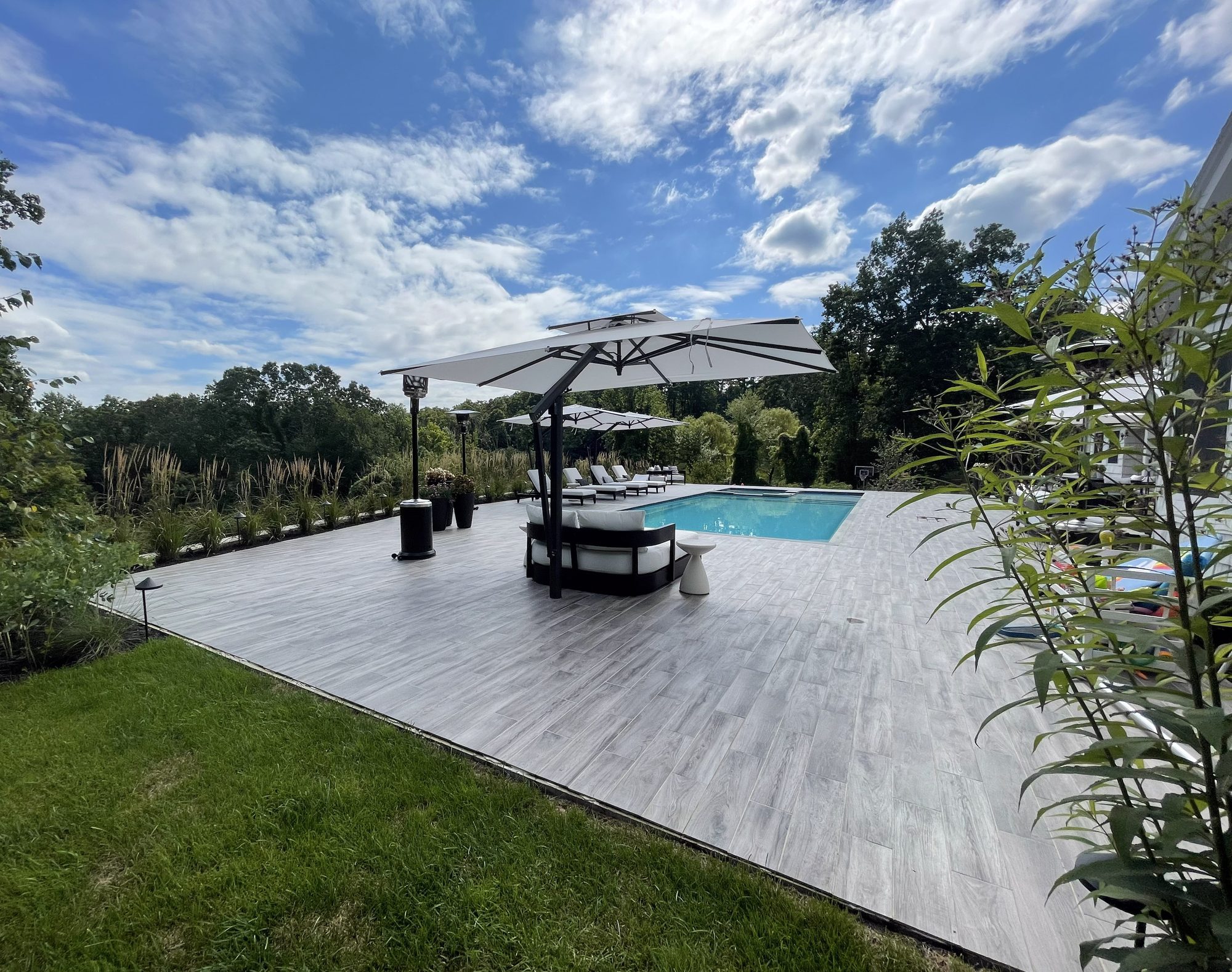 Pool deck with cantilever umbrellas and lounge seating