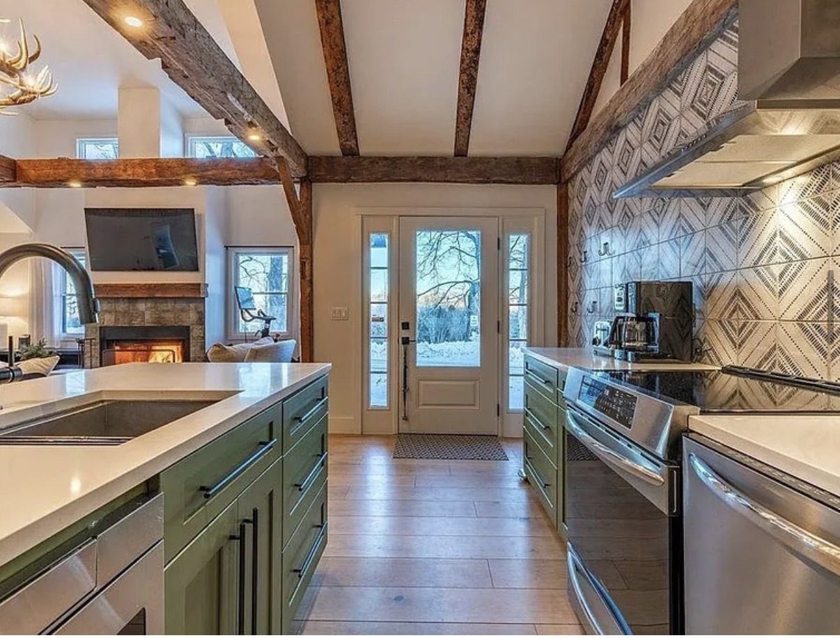 Green kitchen island with patterned tile backsplash