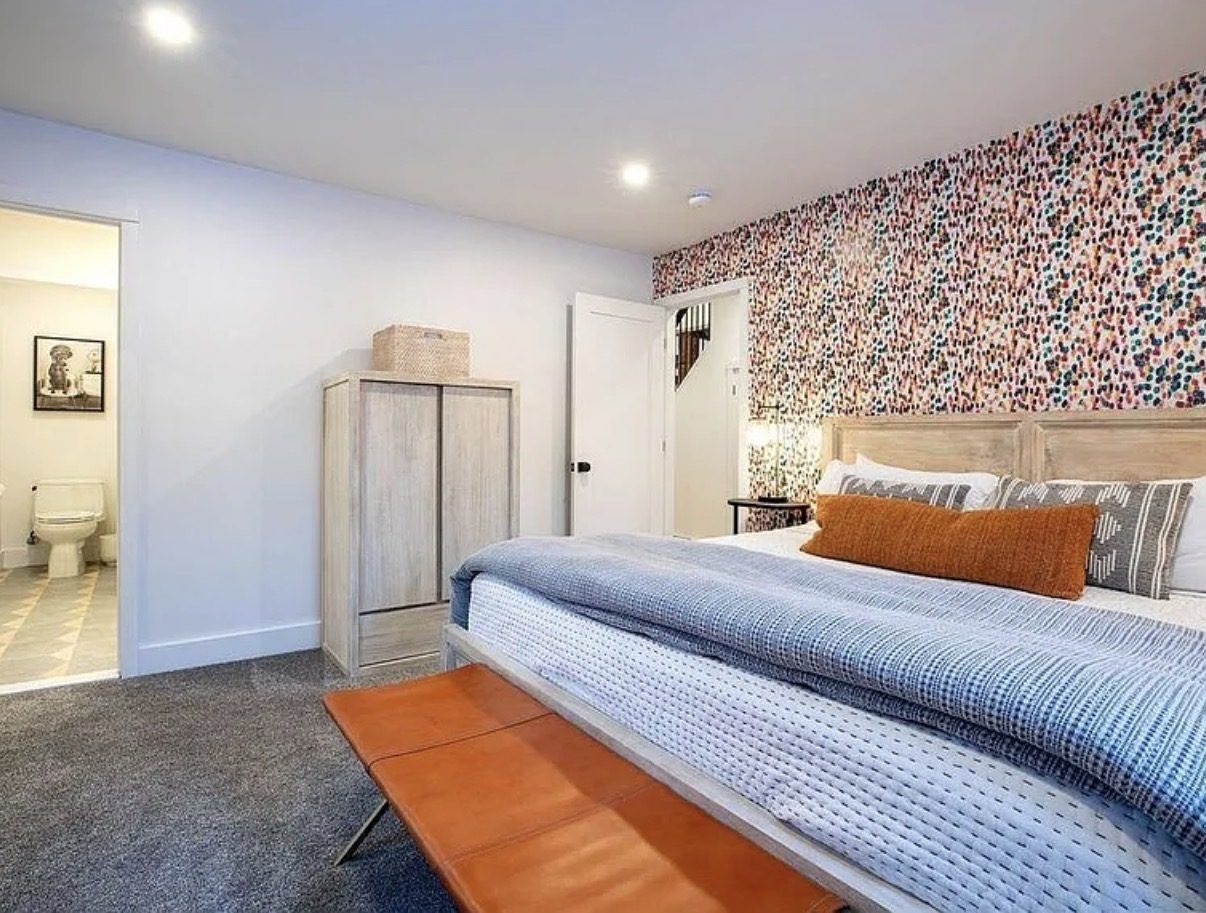 Primary bedroom with patterned accent wall